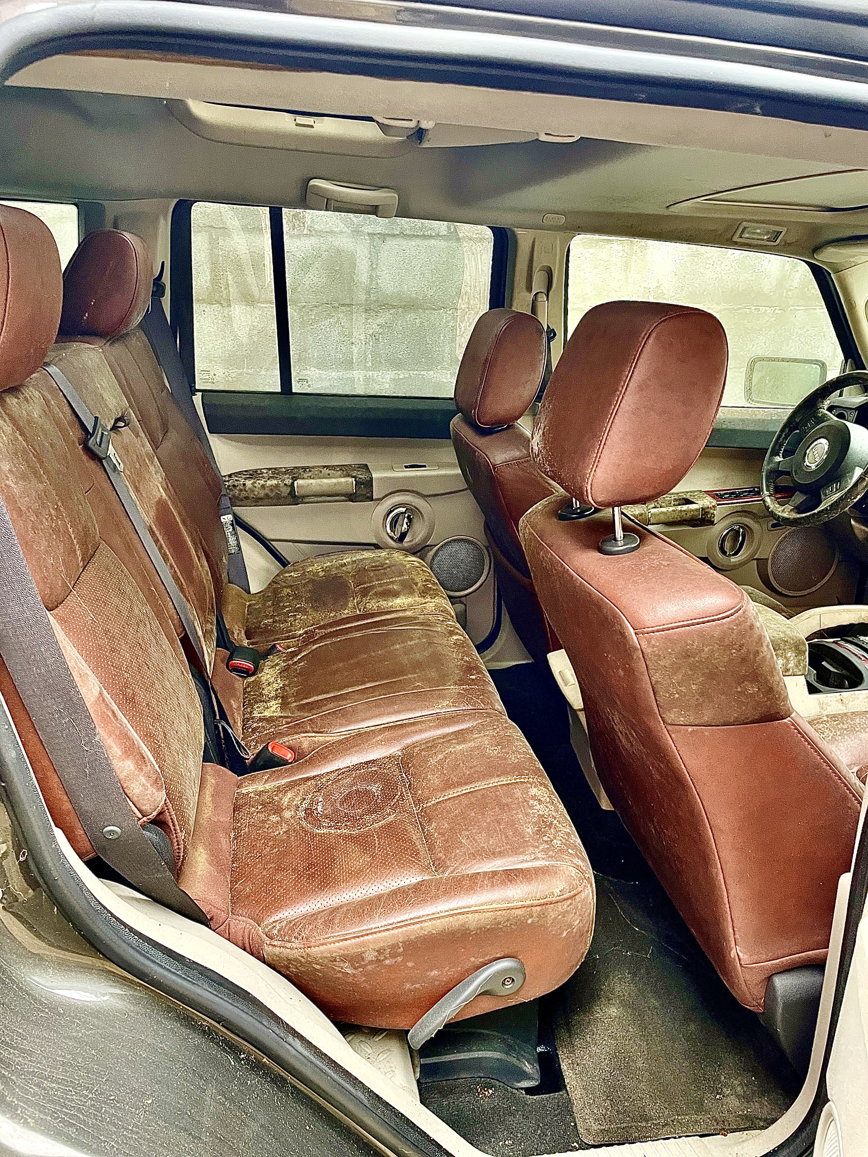 Filthy Jeep Commander backseats before interior detail